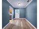 Living room featuring new floors and freshly painted walls next to the kitchen at 1238 Honeytree E Ln, Lakeland, FL 33801