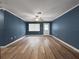 Spacious living room featuring wood-look flooring, neutral walls, and ample natural light at 1238 Honeytree E Ln, Lakeland, FL 33801
