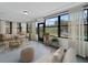 Bright sunroom with neutral furniture, large windows, and views of the backyard pool at 1238 Honeytree E Ln, Lakeland, FL 33801