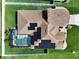 Aerial view of a fenced home with a screened-in pool, well-maintained lawn, and roof with solar panels at 449 Moscato Dr, Davenport, FL 33897