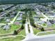 Aerial view of a residential community with tree-lined streets and well-maintained landscaping at 449 Moscato Dr, Davenport, FL 33897