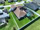 Aerial view of home featuring a large yard with a white fence, solar panels and a screened pool at 449 Moscato Dr, Davenport, FL 33897