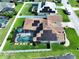 Aerial view of a home with a screened-in pool and solar panels on the roof at 449 Moscato Dr, Davenport, FL 33897