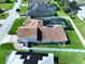Aerial view of a home with solar panels, a screened pool, and a large yard with a white fence at 449 Moscato Dr, Davenport, FL 33897