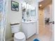 Bathroom with toilet, vanity, and doorway at 449 Moscato Dr, Davenport, FL 33897