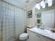 Bathroom with vanity, toilet, and tub with patterned shower curtain at 449 Moscato Dr, Davenport, FL 33897