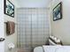 Bathroom with toilet and tub with patterned shower curtain and plant art at 449 Moscato Dr, Davenport, FL 33897