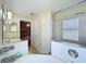 Bright bathroom featuring vanity with sink, glass-enclosed shower and soaking tub at 449 Moscato Dr, Davenport, FL 33897