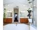 Large bathroom with dual vanities, a garden tub, walk-in shower and hanging plants at 449 Moscato Dr, Davenport, FL 33897