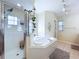 Modern bathroom featuring a shower, garden tub, tiled flooring, and neutral wall paint at 449 Moscato Dr, Davenport, FL 33897