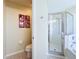 Bathroom with a toilet, glass-enclosed shower, and Disney character art at 449 Moscato Dr, Davenport, FL 33897