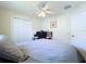 Bedroom featuring full bed, ceiling fan, window, and closet at 449 Moscato Dr, Davenport, FL 33897