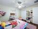A bedroom featuring a closet, wood floors, desk and whimsical decor at 449 Moscato Dr, Davenport, FL 33897