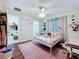 A bedroom with wood floors, starry ceiling, and a peek into the attached bathroom at 449 Moscato Dr, Davenport, FL 33897