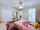 Cozy bedroom with wood floors, ceiling fan and access to the bathroom at 449 Moscato Dr, Davenport, FL 33897