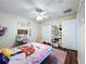 A room featuring a closet, starry ceiling, wood floors and whimsical decor at 449 Moscato Dr, Davenport, FL 33897