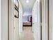 Hallway view leading into a well-lit bedroom with a neutral color palette at 449 Moscato Dr, Davenport, FL 33897