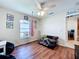 Bedroom featuring wood floors, ceiling fan, a window, and a pet cage at 449 Moscato Dr, Davenport, FL 33897