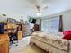 Bright bedroom featuring a ceiling fan, large windows, and ample dresser space at 449 Moscato Dr, Davenport, FL 33897