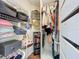 Organized walk-in closet with ample shelving, hanging space, and storage drawers for clothing and accessories at 449 Moscato Dr, Davenport, FL 33897