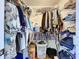 Functional closet features a variety of clothing items, shelving, and wire racks for storage optimization at 449 Moscato Dr, Davenport, FL 33897