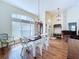 Bright dining area with wood floors, arched window, and stylish white chairs at 449 Moscato Dr, Davenport, FL 33897