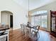 Dining area features hardwood floors and a charming chandelier at 449 Moscato Dr, Davenport, FL 33897