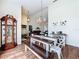 Open-concept dining room with wood floors, long bench, and view of living area at 449 Moscato Dr, Davenport, FL 33897