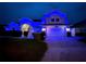 Charming two-story home featuring blue exterior lighting and a well-manicured front yard at 449 Moscato Dr, Davenport, FL 33897