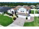 Aerial view of a two-story home with a well-manicured lawn and landscaping at 449 Moscato Dr, Davenport, FL 33897