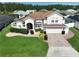 Charming two-story home with a well-manicured lawn and a brick driveway at 449 Moscato Dr, Davenport, FL 33897