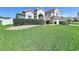 Beautiful two-story home with lush landscaping and a well-maintained lawn at 449 Moscato Dr, Davenport, FL 33897