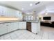 Modern kitchen featuring white cabinets, stainless steel dishwasher, and tile flooring at 449 Moscato Dr, Davenport, FL 33897
