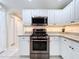Updated kitchen with white cabinets, stainless steel appliances, and granite counters at 449 Moscato Dr, Davenport, FL 33897