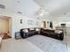 Open concept living area features a large leather sectional, tile floors, and seamless transition to the kitchen at 449 Moscato Dr, Davenport, FL 33897