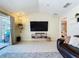 Living room featuring tile flooring, a mounted TV, and sliding glass doors leading to the pool area at 449 Moscato Dr, Davenport, FL 33897