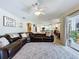 Spacious living room with an inviting leather sectional and seamless transition to the outdoor patio at 449 Moscato Dr, Davenport, FL 33897