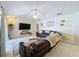 Cozy living room with vaulted ceilings, ceiling fan, and leather furniture at 449 Moscato Dr, Davenport, FL 33897