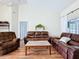 Spacious living room with leather sofas and hardwood floors at 449 Moscato Dr, Davenport, FL 33897