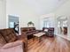 Comfortable living room includes a leather sofa set and hardwood flooring at 449 Moscato Dr, Davenport, FL 33897