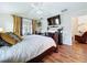 Well-appointed main bedroom with a sliding glass door, ceiling fan, wood floors, and modern furniture at 449 Moscato Dr, Davenport, FL 33897