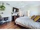 Bright main bedroom featuring wood floors, a ceiling fan, and a dresser with decorative plants at 449 Moscato Dr, Davenport, FL 33897