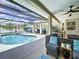 Relaxing screened-in pool and patio area with comfortable seating and a ceiling fan at 449 Moscato Dr, Davenport, FL 33897