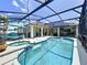Gorgeous screened-in pool area with a spa and lounge chairs, perfect for relaxation at 449 Moscato Dr, Davenport, FL 33897