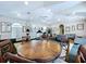 Well-lit recreation room featuring exercise equipment, tables, chairs and sitting area at 449 Moscato Dr, Davenport, FL 33897