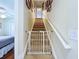 Carpeted staircase with safety gate and picture frames hanging on the wall at 449 Moscato Dr, Davenport, FL 33897