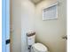 Bathroom features a toilet and small window with blinds at 449 Moscato Dr, Davenport, FL 33897