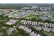 Expansive aerial view showcases a community with ponds, green spaces, and well-maintained homes at 776 Grasslands Village Cir # 776, Lakeland, FL 33803