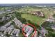Aerial view of community showcasing well-maintained residences, lush landscaping, and a golf course at 776 Grasslands Village Cir # 776, Lakeland, FL 33803