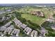 Scenic aerial view of community with golf course, lush greenery, and beautiful homes at 776 Grasslands Village Cir # 776, Lakeland, FL 33803